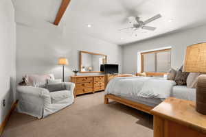 Bedroom featuring beamed ceiling, ceiling fan, and light carpet