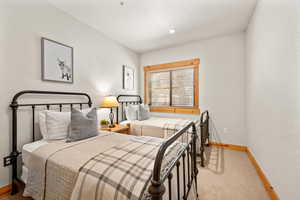 Bedroom with light colored carpet