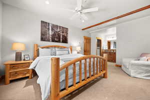 Carpeted bedroom with ensuite bath, ceiling fan, and a closet