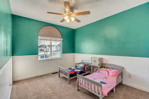 Bedroom featuring ceiling fan and light carpet