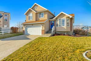 View of front of home with a garage and a front yard