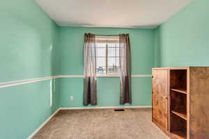 Empty room featuring carpet floors