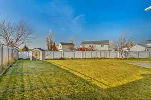 View of yard with a storage unit