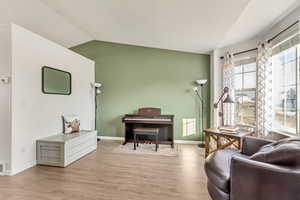 Living area featuring light hardwood / wood-style flooring and vaulted ceiling