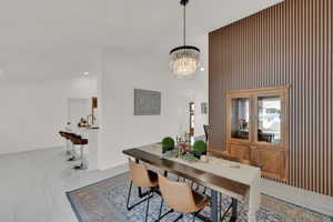 Dining area with high vaulted ceiling and a notable chandelier