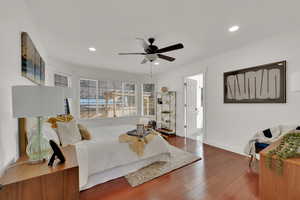 Bedroom featuring connected bathroom, dark hardwood / wood-style floors, and ceiling fan