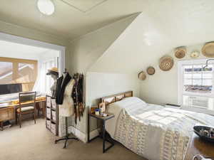 Carpeted bedroom with cooling unit and lofted ceiling