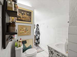 Bathroom featuring tile patterned flooring and toilet