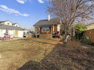 Rear view of property featuring a yard