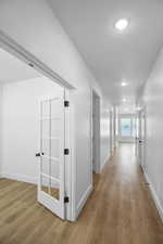 Hall featuring hardwood / wood-style flooring and a textured ceiling