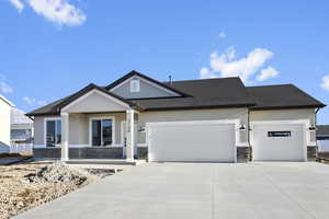 View of front of home featuring covered porch and a garage