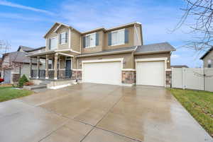 View of front of home featuring a garage and covered porch