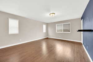 Empty room featuring dark wood-type flooring