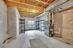 Basement featuring heating unit