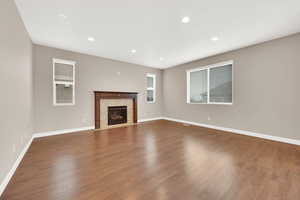 Unfurnished living room featuring dark hardwood / wood-style floors