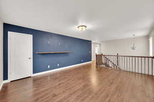 Unfurnished room featuring dark hardwood / wood-style flooring