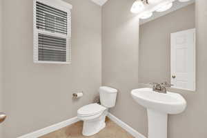 Bathroom featuring tile patterned flooring and toilet