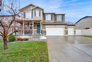 View of front of home featuring a front yard and a garage