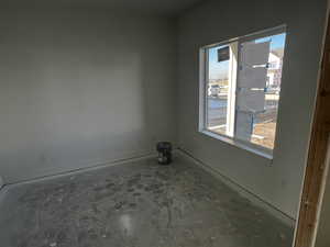 Empty room featuring concrete floors and a healthy amount of sunlight