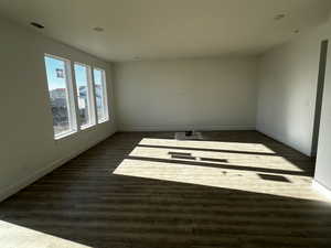 Spare room with dark wood-type flooring