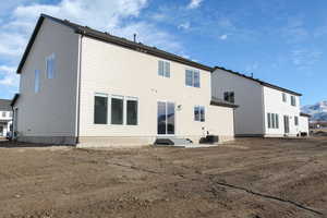 Rear view of property with central AC unit and a mountain view