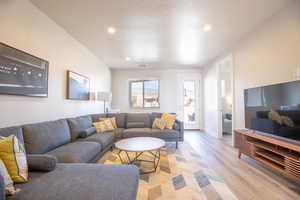 Living room featuring a textured ceiling and light wood-type flooring