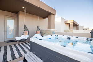 View of patio with a hot tub