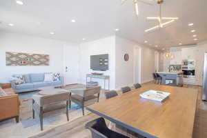 Dining space with sink and light wood-type flooring