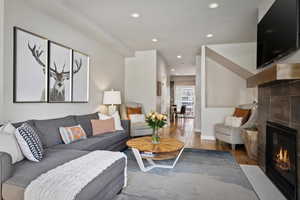 Living room with a fireplace and light hardwood / wood-style flooring