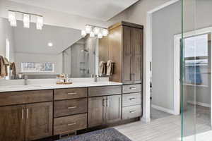 Bathroom featuring a tile shower and vanity