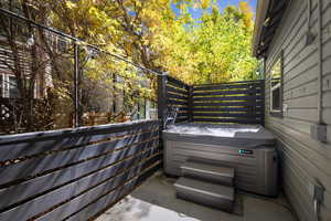 View of patio with a hot tub