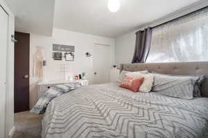 Carpeted bedroom with a textured ceiling