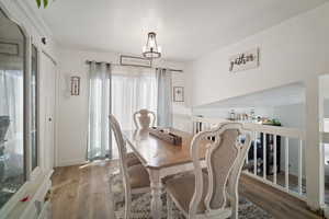 Dining space featuring a chandelier and hardwood / wood-style flooring