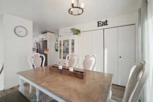 Dining room featuring dark hardwood / wood-style floors and a chandelier