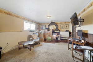 Office space featuring a textured ceiling and carpet floors