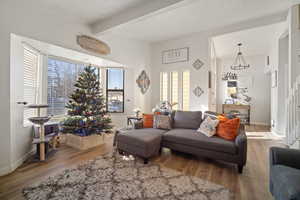 Living room with beam ceiling and wood-type flooring