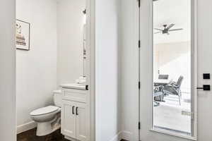 Bathroom with ceiling fan, vanity, and toilet