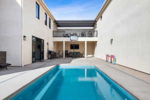 View of swimming pool featuring area for grilling and a patio