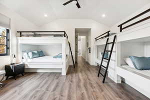 Bedroom with ceiling fan, vaulted ceiling, and hardwood / wood-style flooring