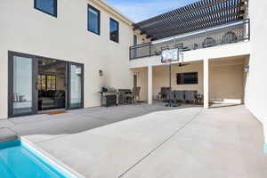 Rear view of house with a patio and a balcony