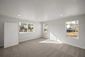 Spare room with light colored carpet