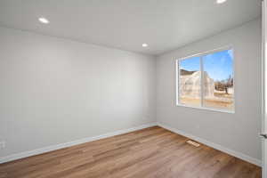 Spare room with light hardwood / wood-style flooring