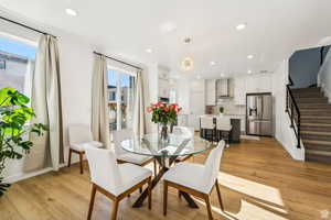 Dining area featuring a chandelier, a healthy amount of sunlight, and light hardwood / wood-style floors