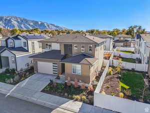 View of front of property with a mountain view and a garage