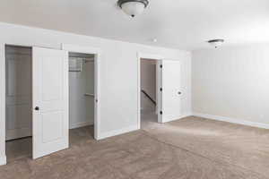 Unfurnished bedroom featuring carpet and a closet