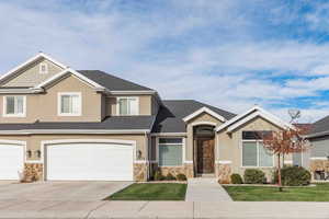 View of front facade featuring a garage