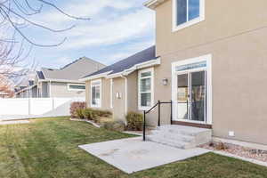 Doorway to property with a lawn