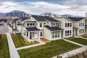 Front view of house with a mountain view and a yard