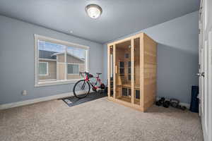 Workout room featuring carpet flooring and a textured ceiling