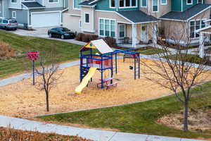 View of jungle gym featuring a lawn